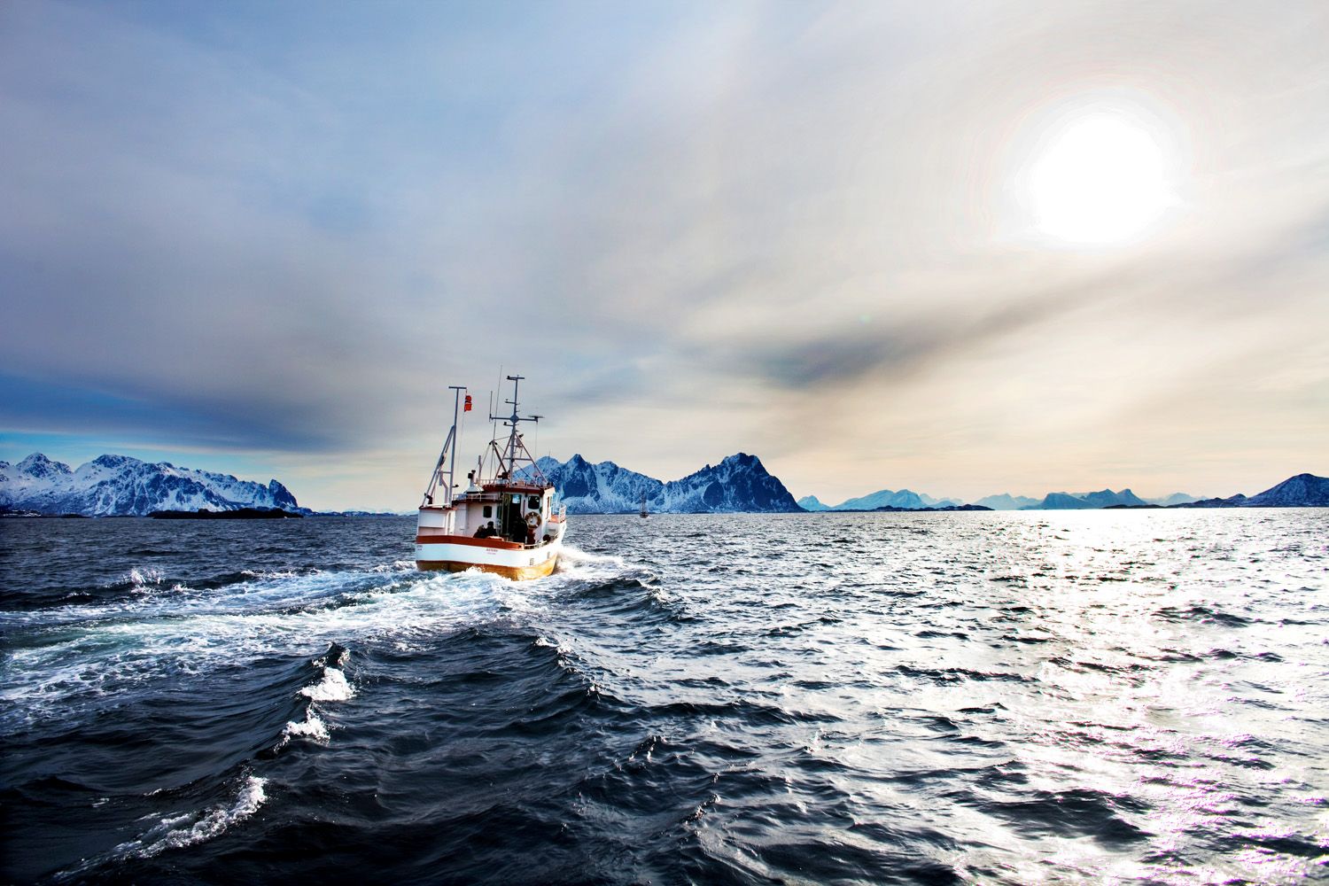 A coastal fishing vessel heading out along the Norwegian coast